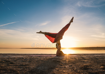 Silhouette yoga woman on the beach at sunset / Photodune, Misc