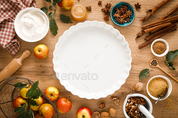 Cooking Thanksgiving autumn apple pie with fresh fruits and walnuts on wooden background, top view / Photodune, Misc