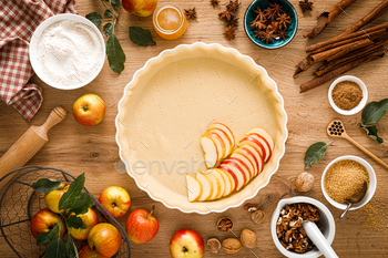 Cooking Thanksgiving autumn apple pie with fresh fruits and walnuts on wooden table, top view / Photodune, Misc