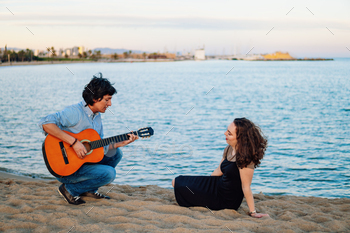 Coverband couple of musicians play acoustic guitar and sing near the beach / Photodune, Misc