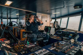 ooking through binoculars. Marine industry. COLREG collision regulations
