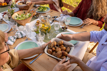 People Passing Tray of Baked Potatoes / Photodune, Misc