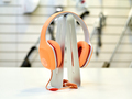 A modern orange headphones for sale in a household appliances store - PhotoDune Item for Sale