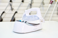 A modern wireless iron for sale in a home appliance store - PhotoDune Item for Sale