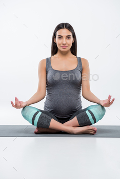 beautiful smiling pregnant asian woman practicing yoga in lotus pose, isolated on grey / Photodune, Misc