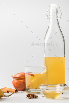 apple cider in bottle and glass with spices on white surface / Photodune, Misc