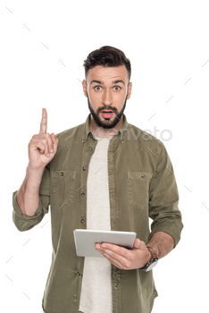 portrait of young emotional man pointing up with tablet in hand isolated on white / Photodune, Misc