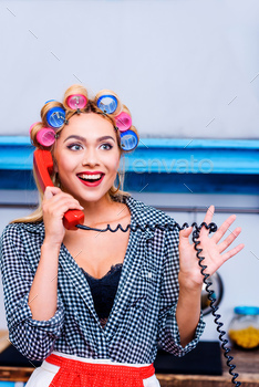 excited attractive woman in curlers talking on vintage telephone / Photodune, Misc
