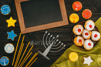 top view of frame, menorah, donuts and cookies with star of david on wooden tabletop, hanukkah / Photodune, Misc