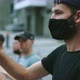 Rebel Regulations Activist in Face Mask Claps Hands in Crowded Marching People - VideoHive Item for Sale
