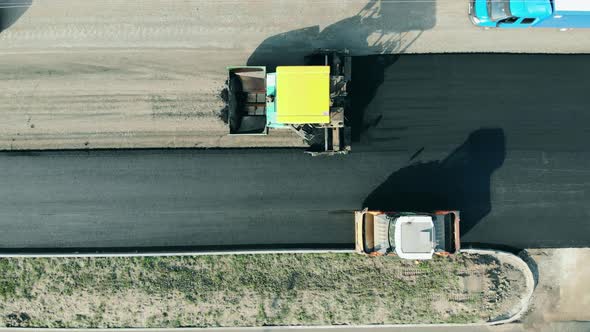 Asphalt Laying Machines Are Manufacturing a Road. Road Construction Concept.