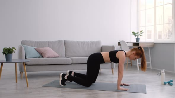 Woman Doing Transition From AllFours To Downward Dog Pose Indoors