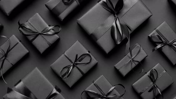 Elegant Black Christmas Theme. Wrapped Gifts in Black Matte Paper with Ribbon