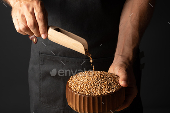 One puts the grain into the bowl with flour shells / Photodune, Misc