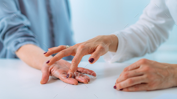 Examining the hand of a senior patient with carpal tunnel syndrome. / Photodune, Misc