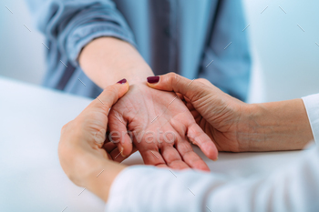 Examining the hand of a senior patient with carpal tunnel syndrome. / Photodune, Misc