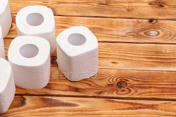 Toilet paper rolls on wooden background top view / Photodune, Misc