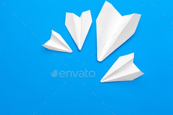 white paper airplane on a navy paper background / Photodune, Misc