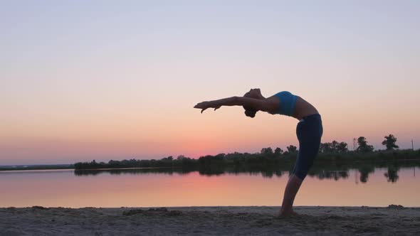 Girl at Sunset Showing Gymnastic Exercises