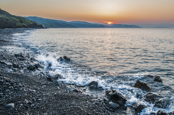 Sunset on the seashore, rocky beach / Photodune, Misc