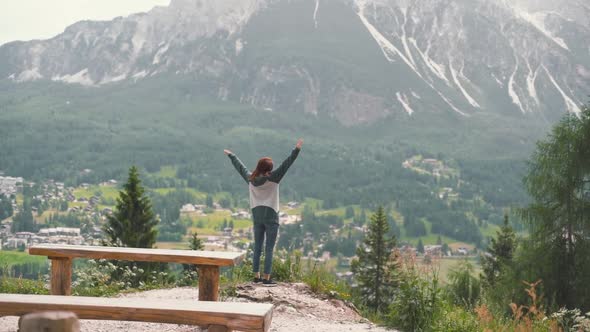 Slow Motion Shot of Happy Young Woman Walks in the Dolomites Mountains Northern Italy in the Summer