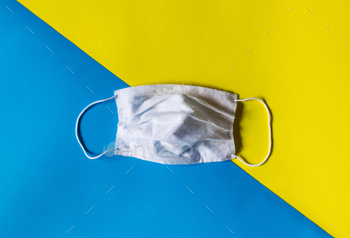 Medical mask against coronavirus covid 19 on colored background / Photodune, Misc