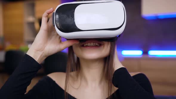 Brunette Wearing Virtual Reality Headset and Moving Hands on Imaginary Screen Being at Home