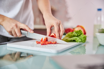 Knife cutting through a pepper on a board / Photodune, Misc
