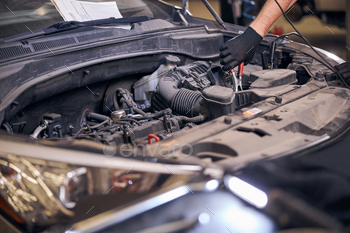 Male worker repairing car engine at service station / Photodune, Misc