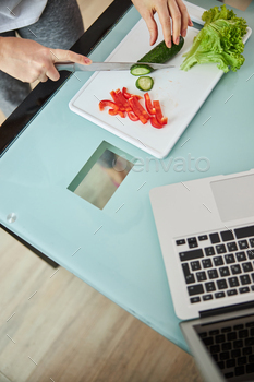 Person with a knife is cutting cucumber / Photodune, Misc