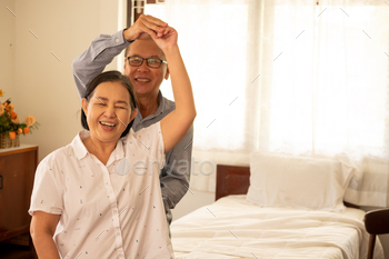 Happy asian couples dancing together in the bedroom. / Photodune, Misc