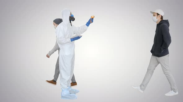 Man in Hazmat Suit Checking Temperature and Stopping Woman on Gradient Background