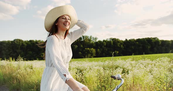 Happy Woman Riding Bicycle on Country Road