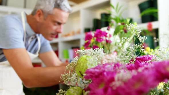 Male florist arranging flower bouquet in flower shop