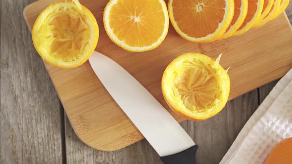 Ripe Juicy Citrus Fruits On A White Kitchen Towel.Manual Juicer. Bamboo Board With Orange Slices