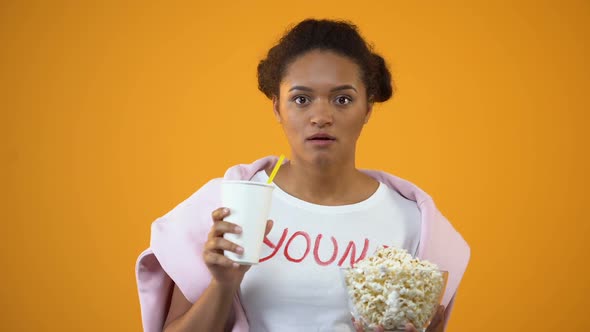 Girl Attentively Watching Movie and Drinking Soft Drink, Influence of Television