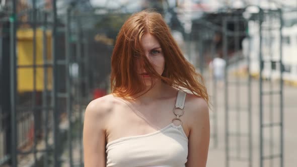 Portrait of Beautiful Smiling Redhaired Woman on Street at Day