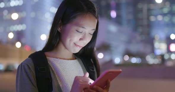 Asian woman use of smart phone at night