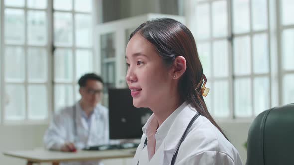 Young Asian Woman Doctor Is Using Computer In Workplace. Medical Concept