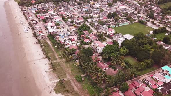 Olon Beach, Ecuador - Aerial Shot Of A Calm Sea and Different Buildings - Aerial Shot