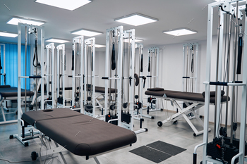 Close up massage bed in recovery center. Interior of physical therapy cabinet. Rehab weight machines / Photodune, Misc