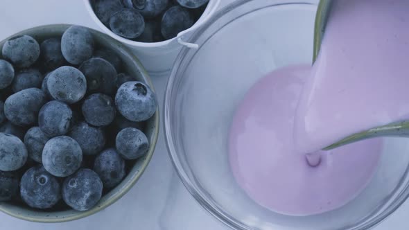 Bowl with Yogurt and Blueberries on Table