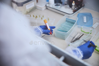 Scientist investigating hazardous substances in a microbiological safety cabinet / Photodune, Misc