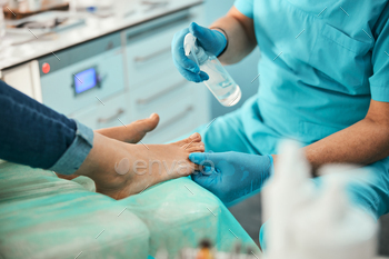 Close up of podiatrist preparing nails for procedure / Photodune, Misc