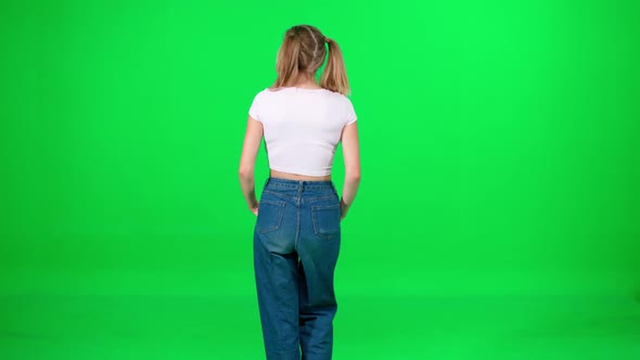 Young Female Walking Down the Street on a Green Background a Passerby on a Walk Chroma Key Template