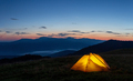 Orange luminous tent on the mountain in evening or early morning - PhotoDune Item for Sale