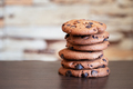 Stack of oatmeal cookies with chocolate on wooden table - PhotoDune Item for Sale