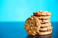 Stack of oatmeal cookies with peanuts on blue background - PhotoDune Item for Sale