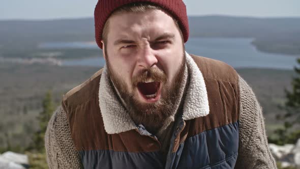 Man with Beard Screaming on Hiking Trip