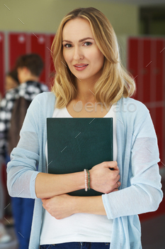 Portrait of teacher smiling in school corridor / Photodune, Misc